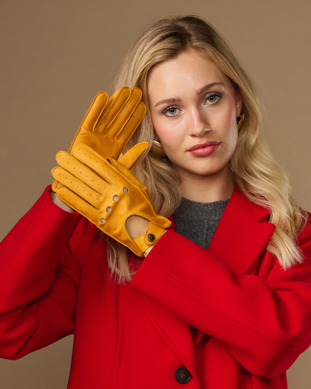 Yellow lambskin driving gloves with touchscreen fingertips and stitched holes