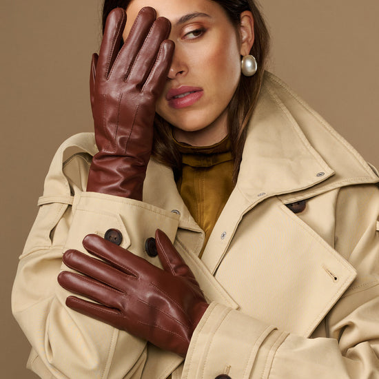 Extra-long brown leather gloves with rabbit-fur lined cuffs worn by model