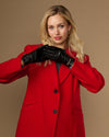 Black leather gloves with gold-tone buckle and stitched finger seams