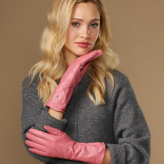 Pink leather gloves with long cuff and textured wrist seam, touchscreen fingertips