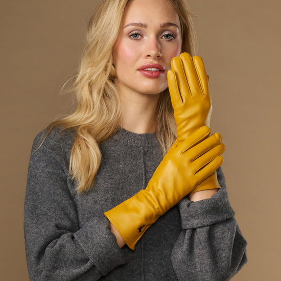 Yellow extra-long leather gloves with cashmere lining; touchscreen fingertips; cuff logo detail