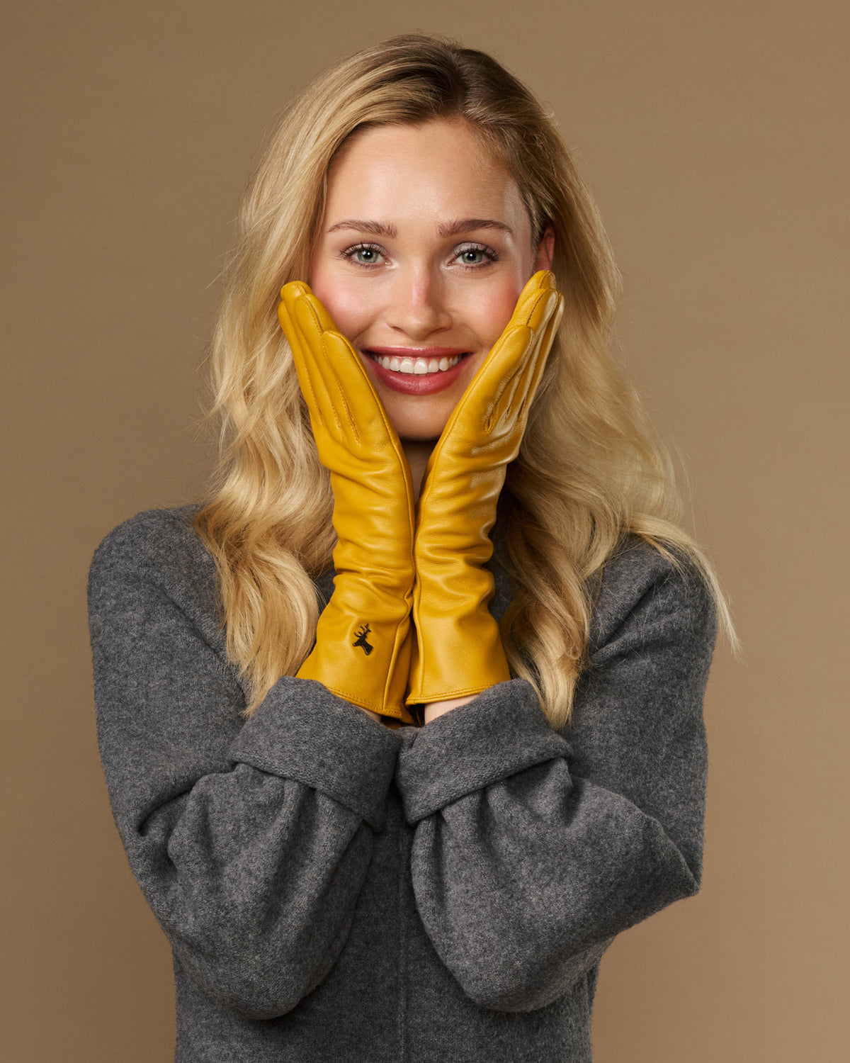 Yellow extra-long leather gloves with cashmere lining; cuff logo; touchscreen fingertips at wrists