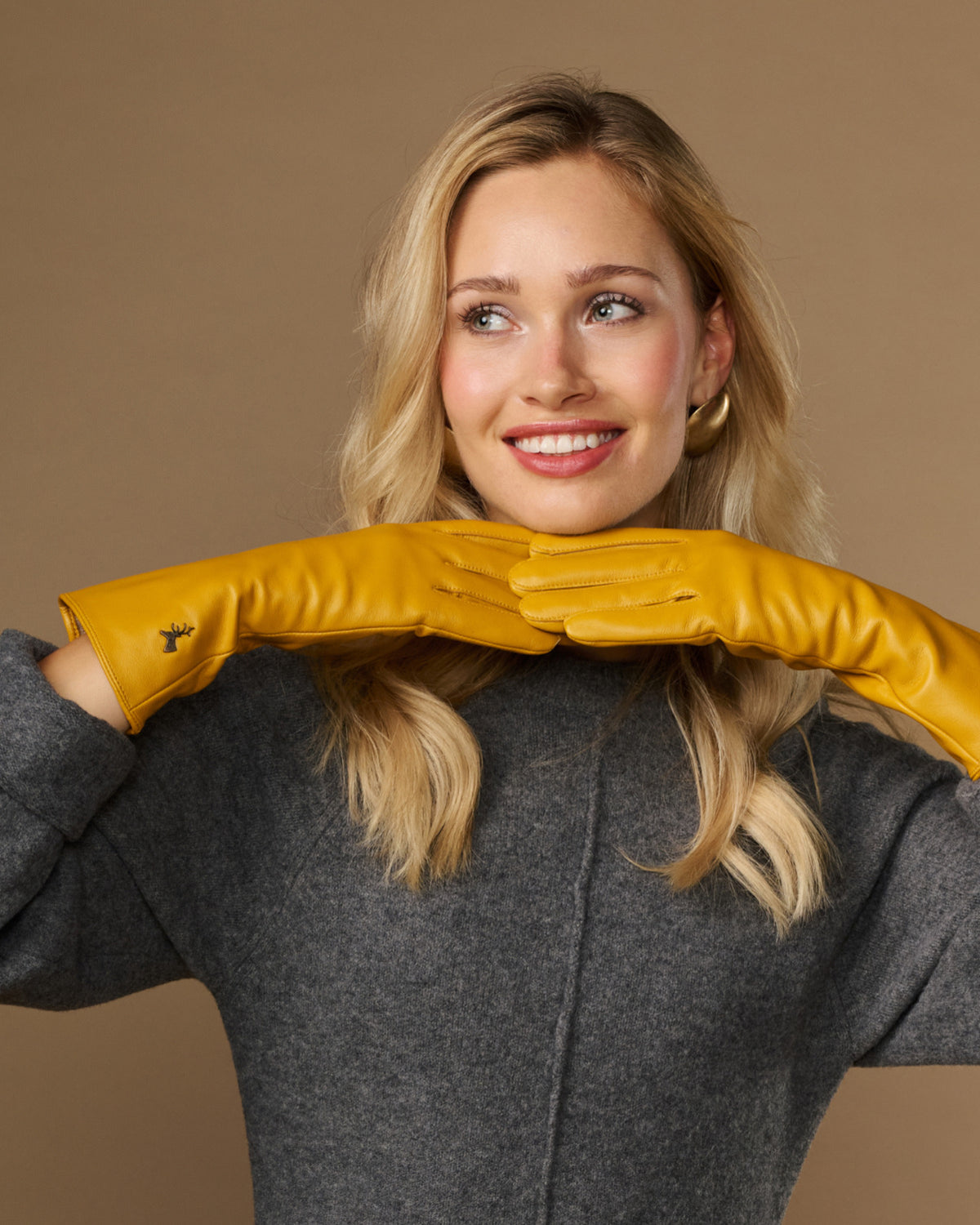Yellow extra-long leather gloves with cashmere lining; cuff logo and touchscreen fingertip area