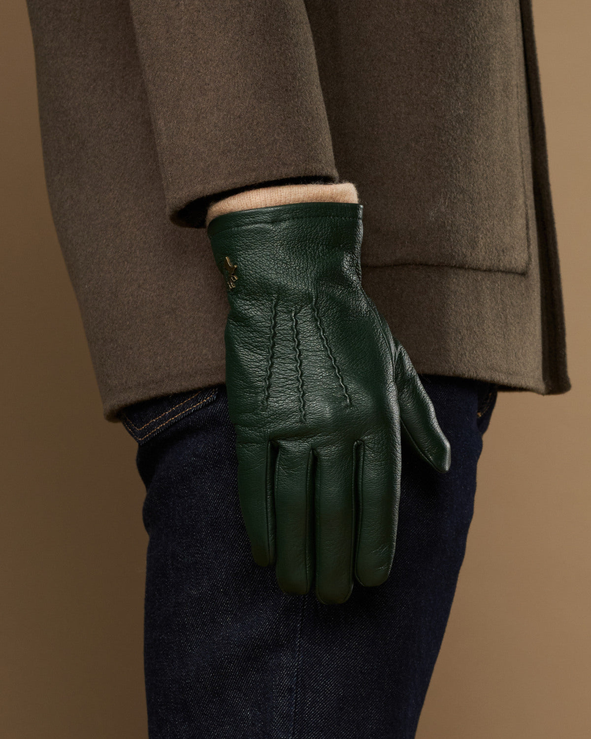 Men's dark green leather glove with wool lining at the wrist cuff