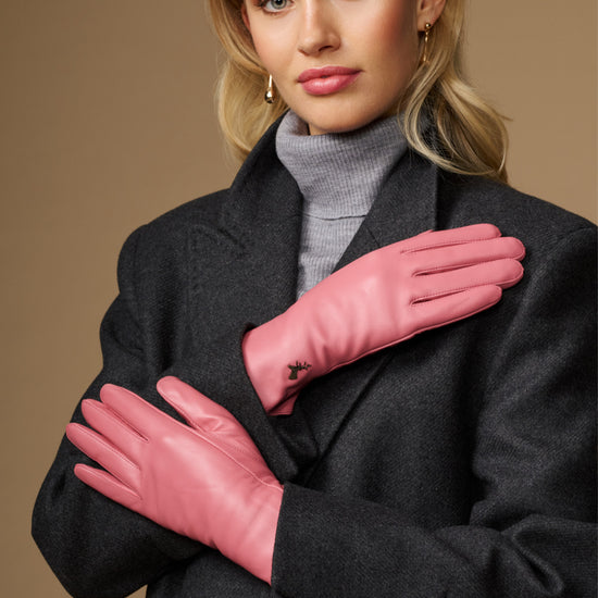 Women’s pink leather gloves with stitched fingers and small logo on back of hand