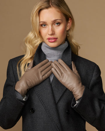 Women’s taupe leather gloves, full-finger style with stitched seams and cuff