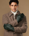 Dark green Jake sheepskin gloves with warm fleece lining, model arms crossed