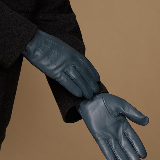 Blue sheepskin gloves with curved finger stitching and soft cuff