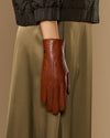 Women’s cognac leather gloves with long fur-lined cuffs and stitched finger panels