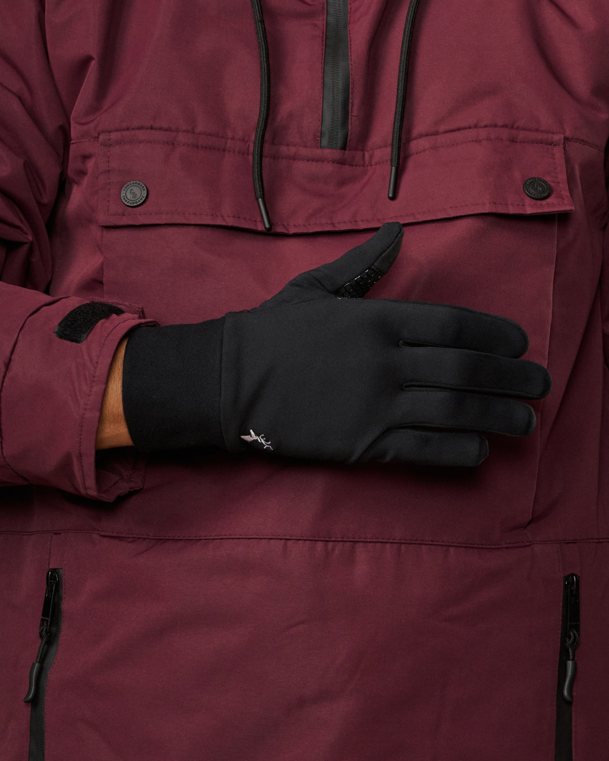 Black activity glove showing the smooth back, cuff, and textured grip at the thumb