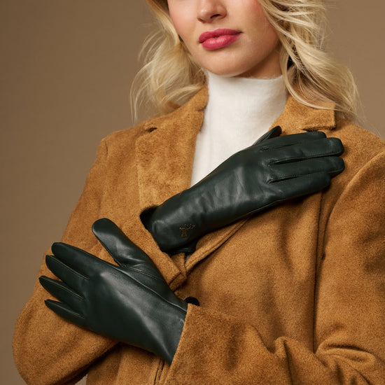 Pair of dark green leather gloves with smooth finish, stitched fingers, and snug cuffs