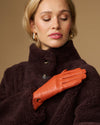 Lauren orange lambskin leather glove with touchscreen tips, silk-lined, close-up fit