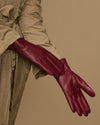 Bordeaux leather gloves, side view showing stitched fingers and long cuff