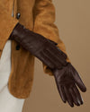 Brown leather gloves with fleece lining, close-up side view of one glove