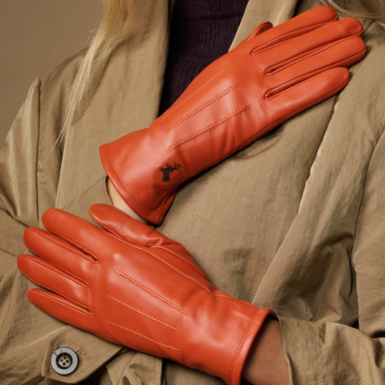 Orange leather gloves with warm fleece lining, close-up view of palm and seams