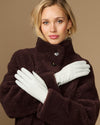 White sheepskin leather gloves with fleece lining, two gloves held across chest