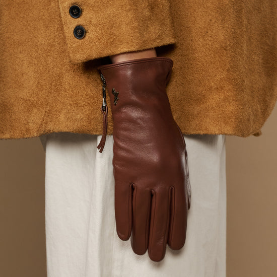 Close-up of brown leather glove side zip and fingertips, cashmere-lined cuff