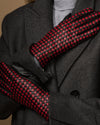 Close-up of women's black gloves with red-and-black checkered palm and fingers
