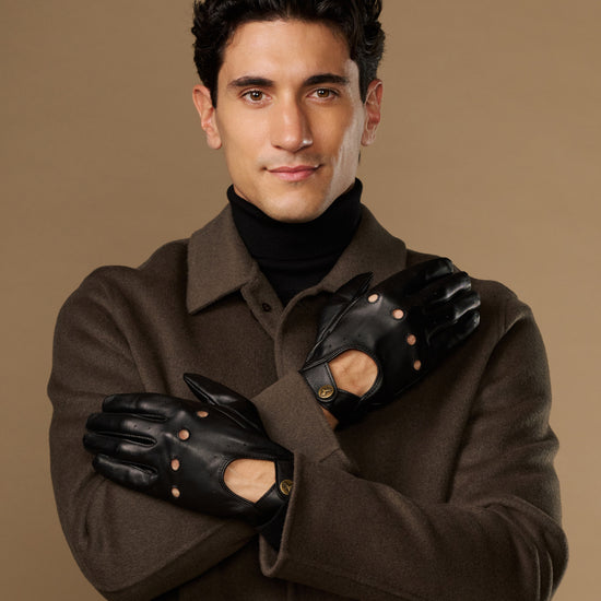 Men's black leather driving gloves with touchscreen fingers and elastic wrist cuffs