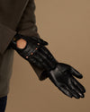 Black leather driving glove with touchscreen opening, worn with cuff and sleeve