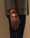 Brown leather driving gloves with elastic wrist and reinforced palm stitching