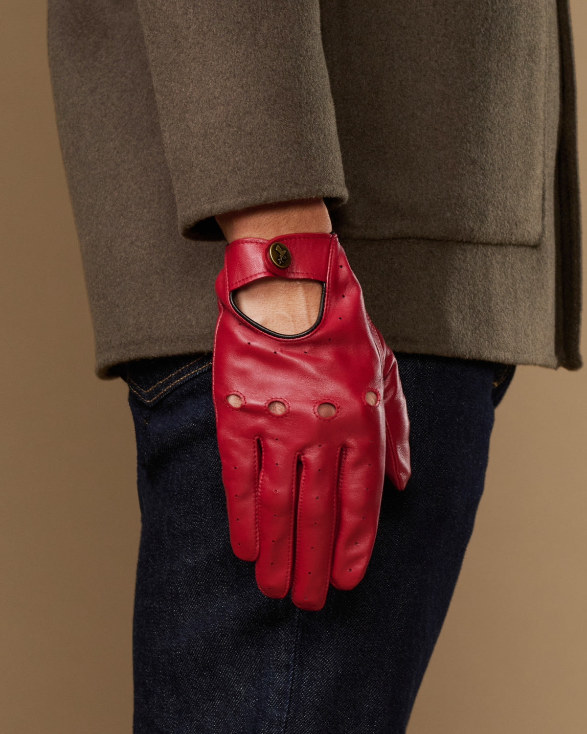 Men's red leather driving gloves with open thumb and buttoned wrist cuff
