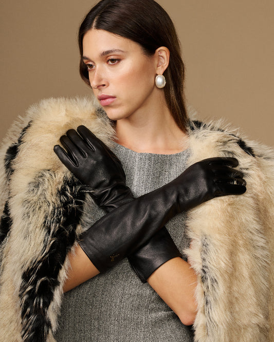 Black below-elbow leather gloves with touchscreen fingertips, glossy finish, ruched cuff
