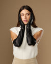Black leather opera gloves with long fingers and silk lining at the cuffs