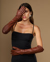 Women's chocolate brown leather gloves with smooth finish and extended elbow length