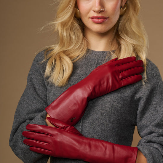 Red lambskin leather mid-forearm gloves with smooth cuffs and stitched fingers