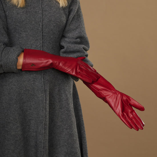 Red leather mid-forearm gloves shown in side profile with detailed stitched seams