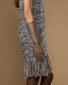 Taupe below-elbow leather glove on arm, long slim cuff with finger seams visible.