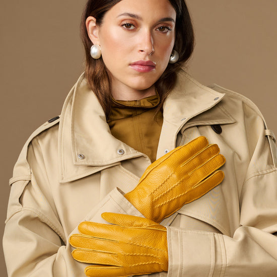 Yellow deerskin leather gloves with stitched fingers and snug wrist cuffs