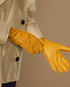 Yellow deerskin leather glove with textured grain, stitched fingers, and wrist cuff