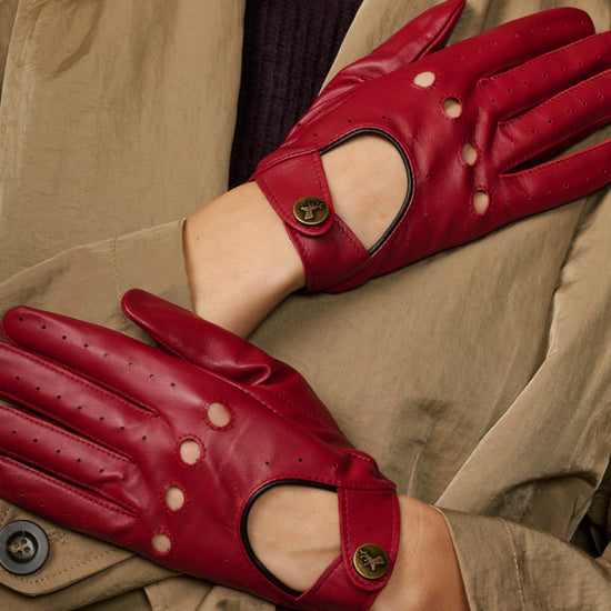 Red leather driving gloves close-up, perforated fingers with thumb cutout