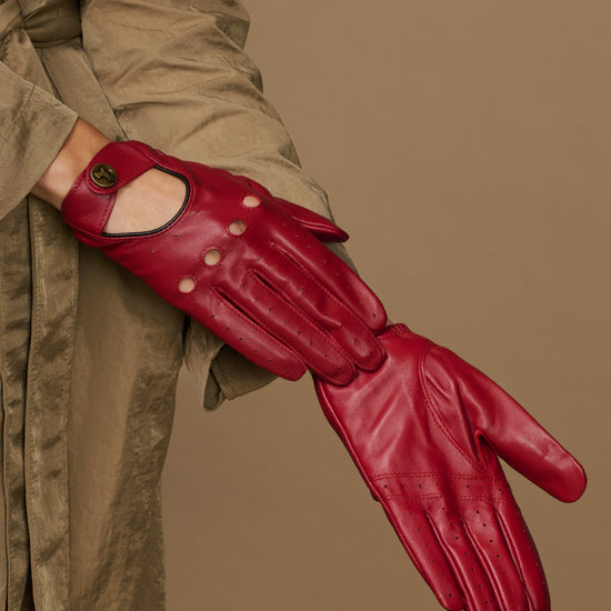 Red leather driving gloves on hand, full finger coverage with knuckle cutout